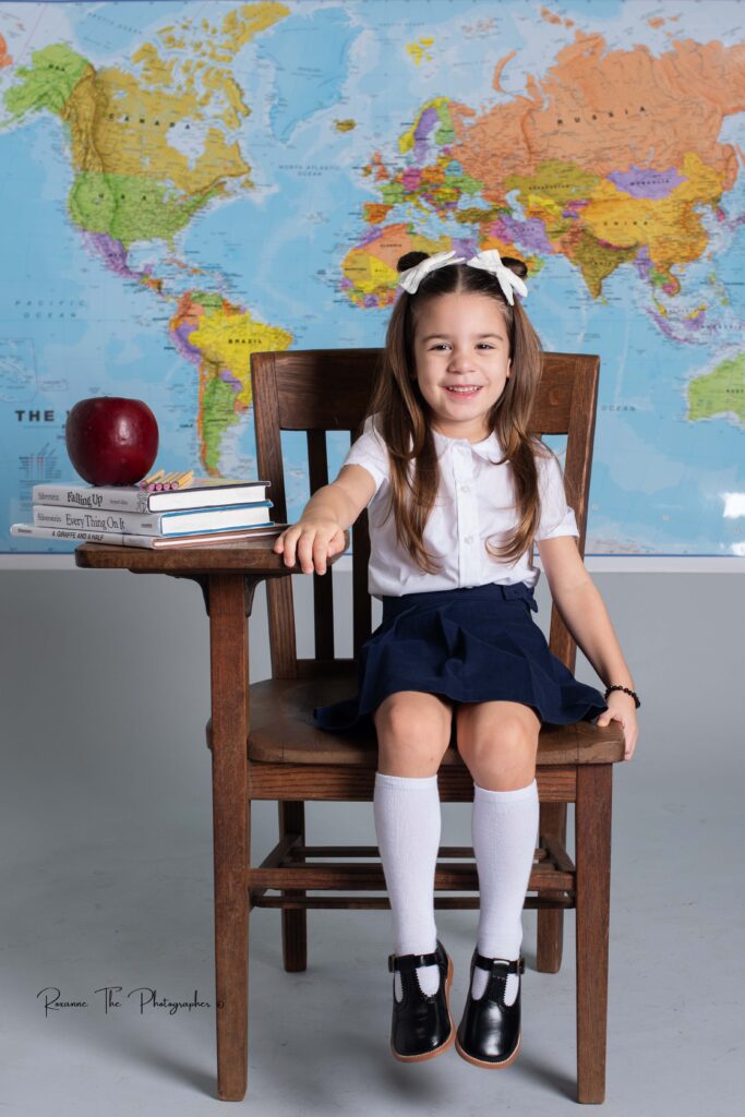 Little girl sitting in a school chair